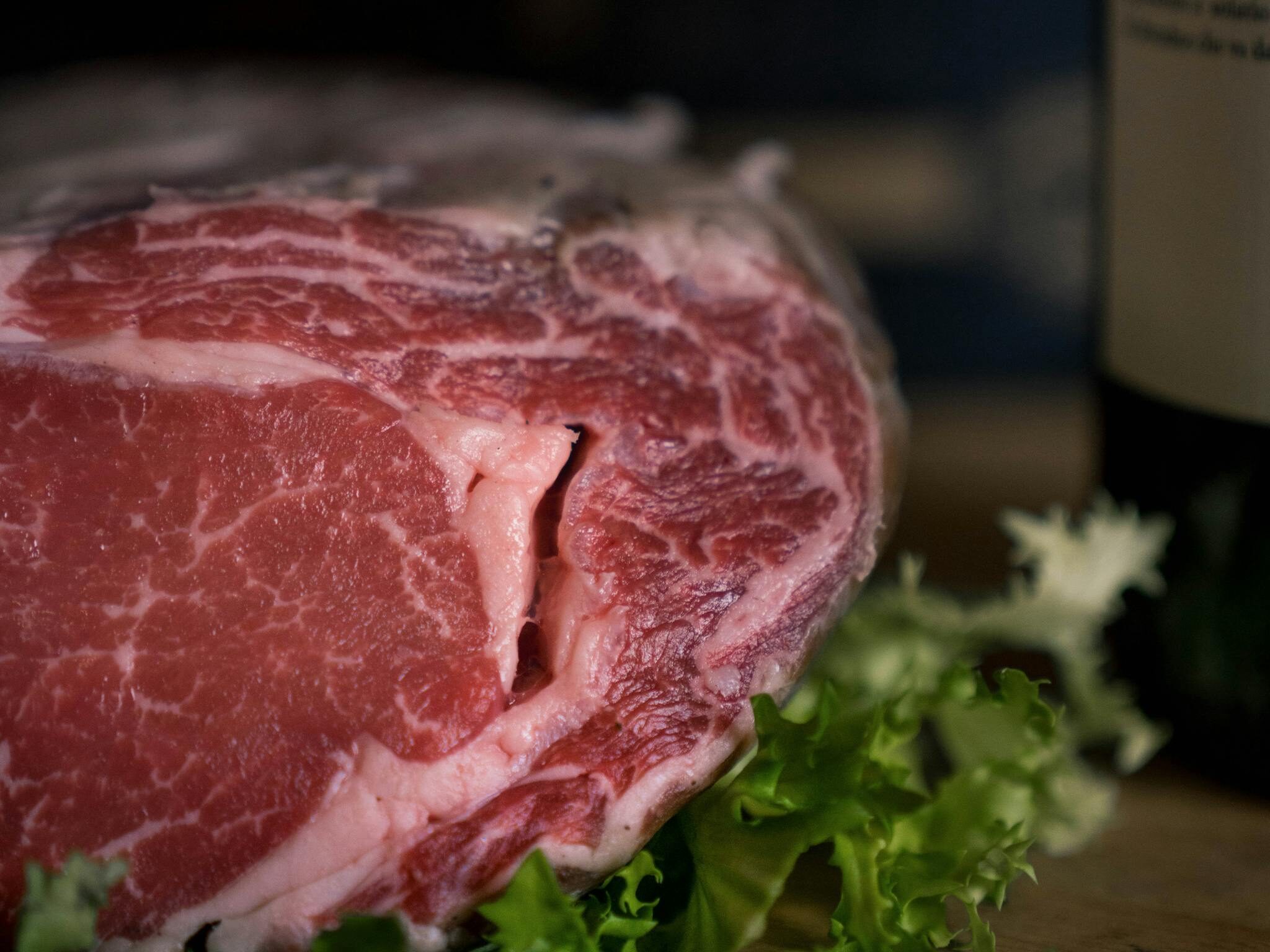 Close-up of Raw Beef Lying on Lettuce